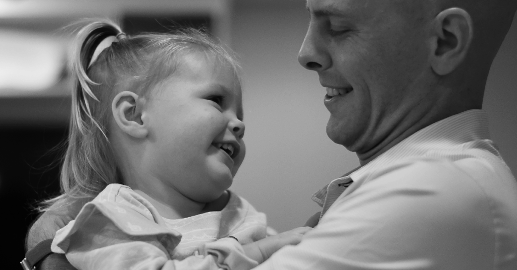 Family enjoying a candid moment during an in-home photo session in Fort Worth